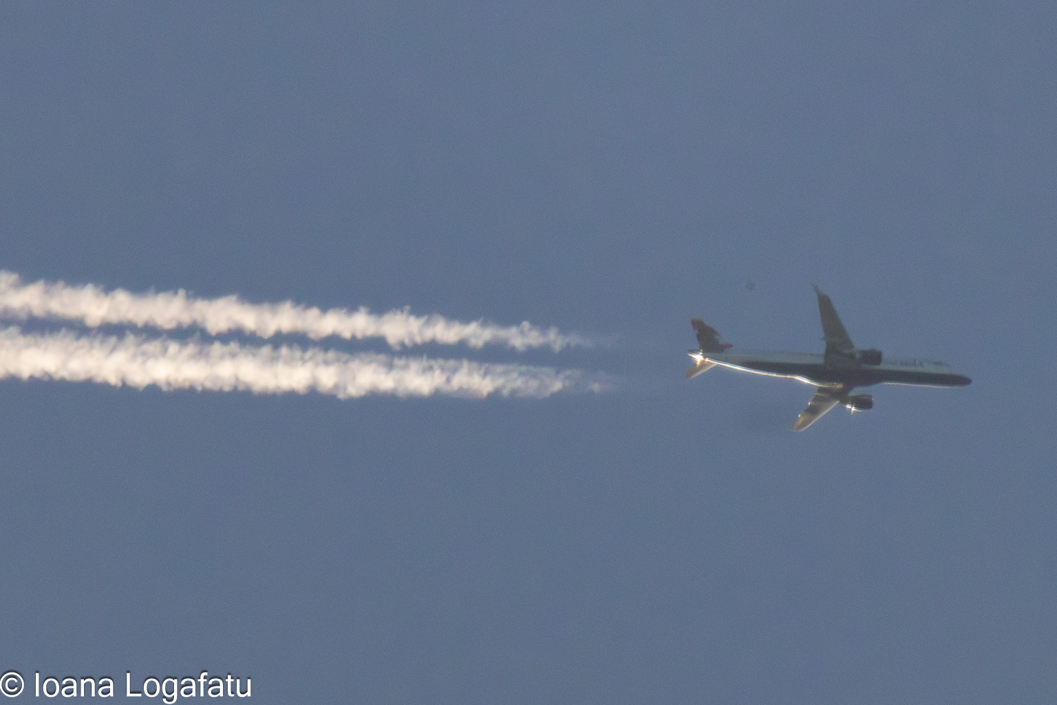 Airplane soaring against a clear blue sky